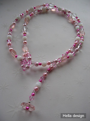 Rosa och vitt prlhalsband med gleslut. 75 cm lngt.